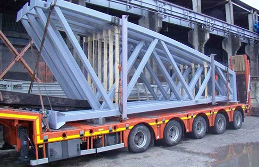 long steel beams loaded on truck trailer, ready for site delivery