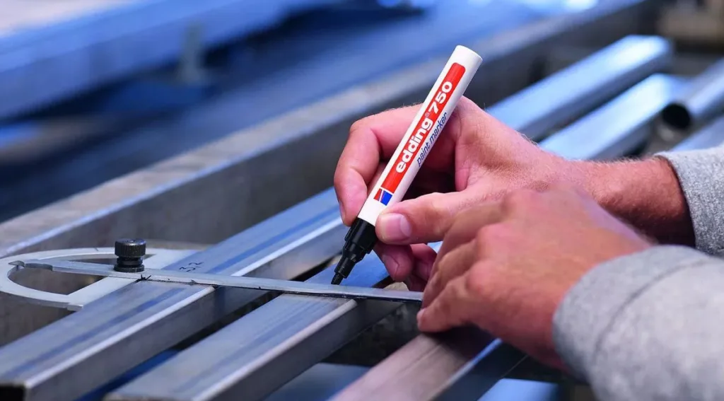 steelworker marking a beam